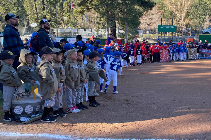 Little League teams gather around the diamond for the opening ceremonies.